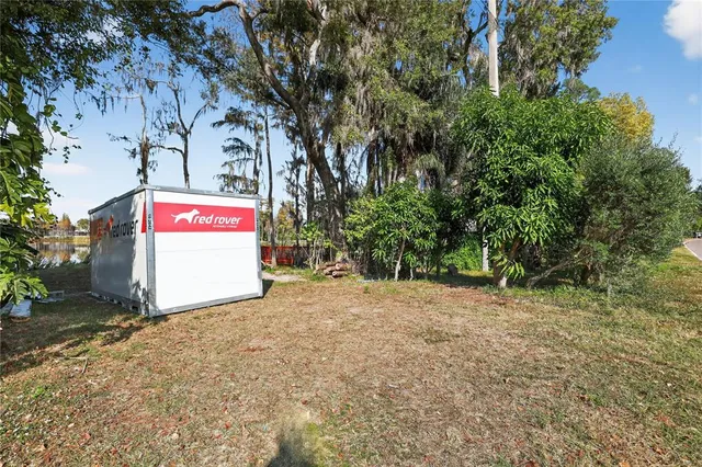 a backyard of a house with barbeque oven table and chairs