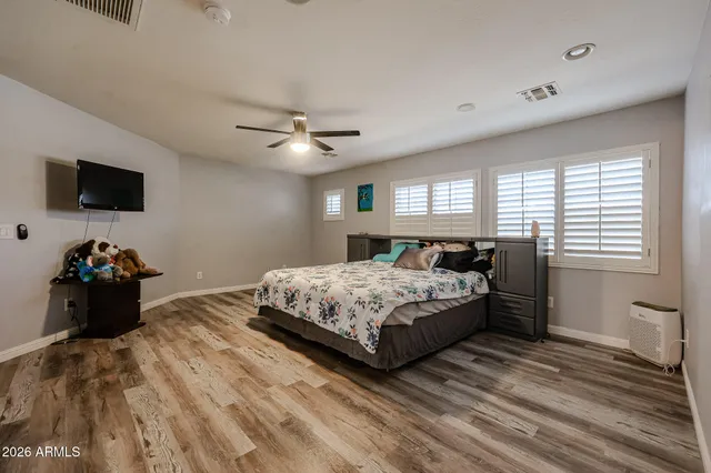 a bedroom with a bed and a tv