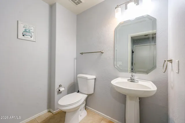 a bathroom with a toilet sink and a mirror