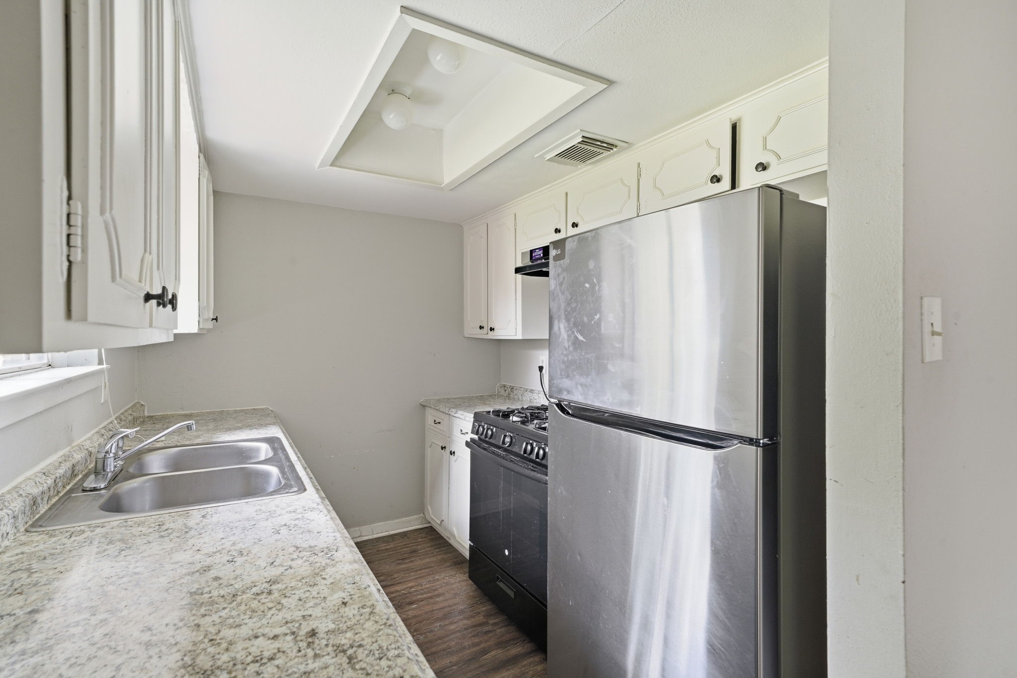 6410 Hopper Road Houston, TX 77016 - Photo 13 of 28 a kitchen with granite countertop a refrigerator and a sink