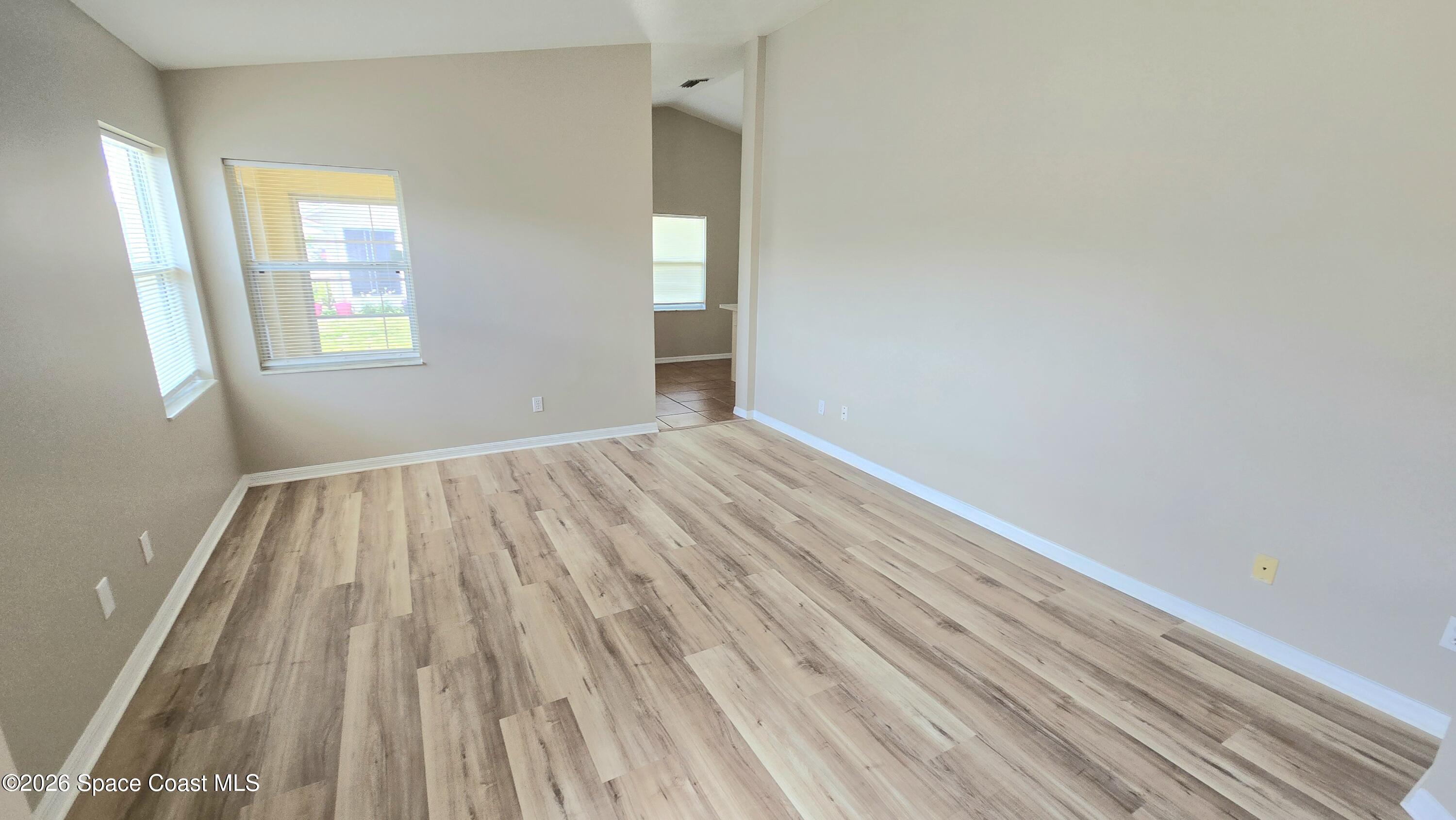 1977 Myrtle Court Palm Bay, FL 32905 - Photo 2 of 19 a view of an empty room with wooden floor and a window