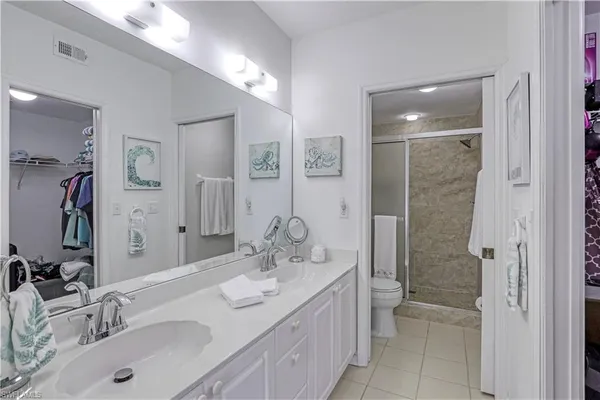 a bathroom with a sink double vanity and a shower