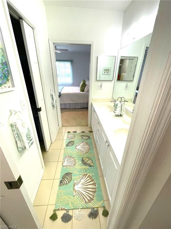 9022 Michael Circle, Unit 2205 Naples, FL 34113 - Photo 14 of 26 a bathroom with a tub sink and mirror