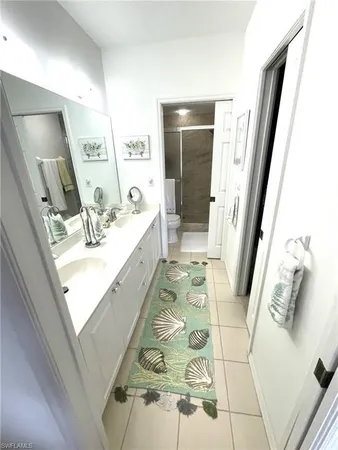 a bathroom with a sink a mirror and shower