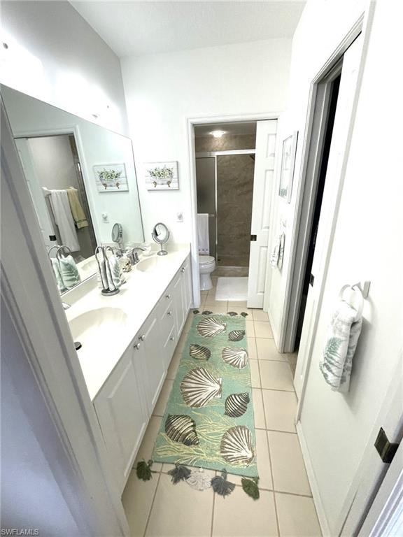 9022 Michael Circle, Unit 2205 Naples, FL 34113 - Photo 15 of 26 a bathroom with a sink a mirror and shower