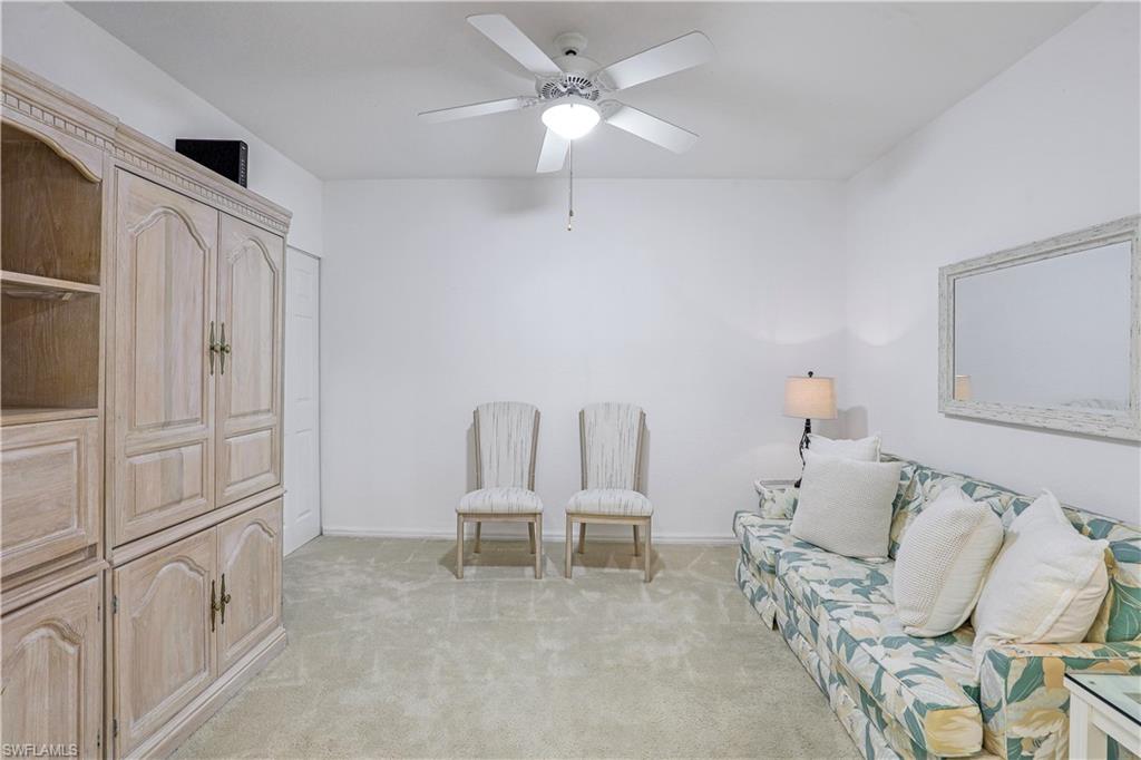 9022 Michael Circle, Unit 2205 Naples, FL 34113 - Photo 18 of 26 a living room with furniture and a chandelier