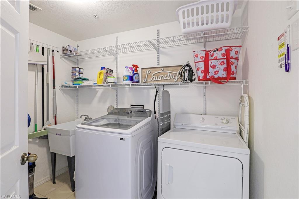 9022 Michael Circle, Unit 2205 Naples, FL 34113 - Photo 19 of 26 a utility room with dryer and washer