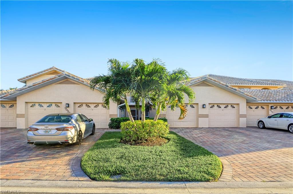 9022 Michael Circle, Unit 2205 Naples, FL 34113 - Photo 21 of 26 a view of a car parked in front of a house