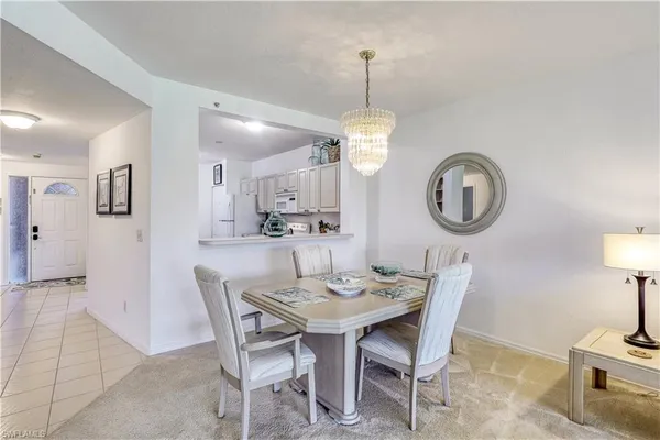 a view of a dining room with furniture and a mirror