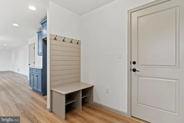 a view of hallway with wooden floor
