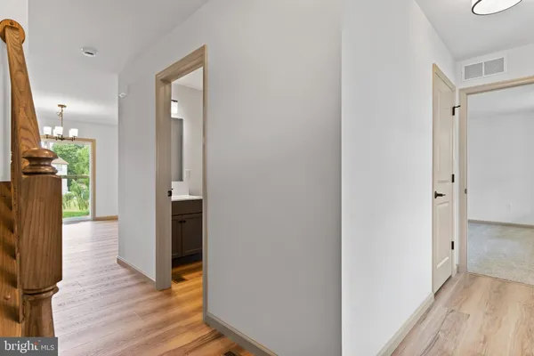 a view of a hallway with wooden floor