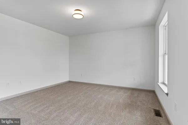 an empty room with a empty space and window