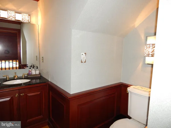 a bathroom with a sink a toilet and mirror