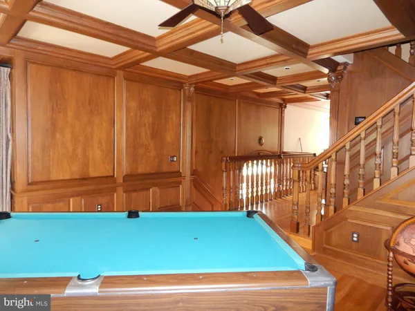 a room with lots of wooden furniture and a book shelf