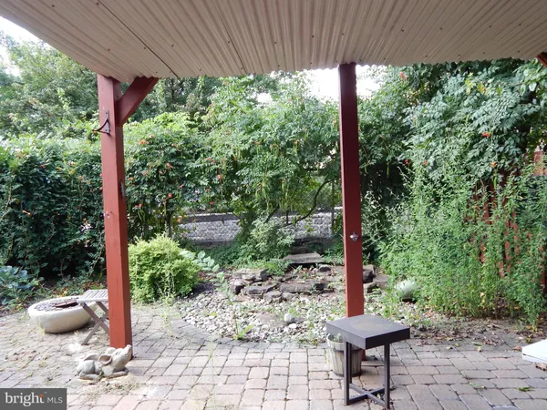 a view of a patio with furniture and garden