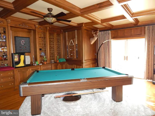a room with pool table and windows
