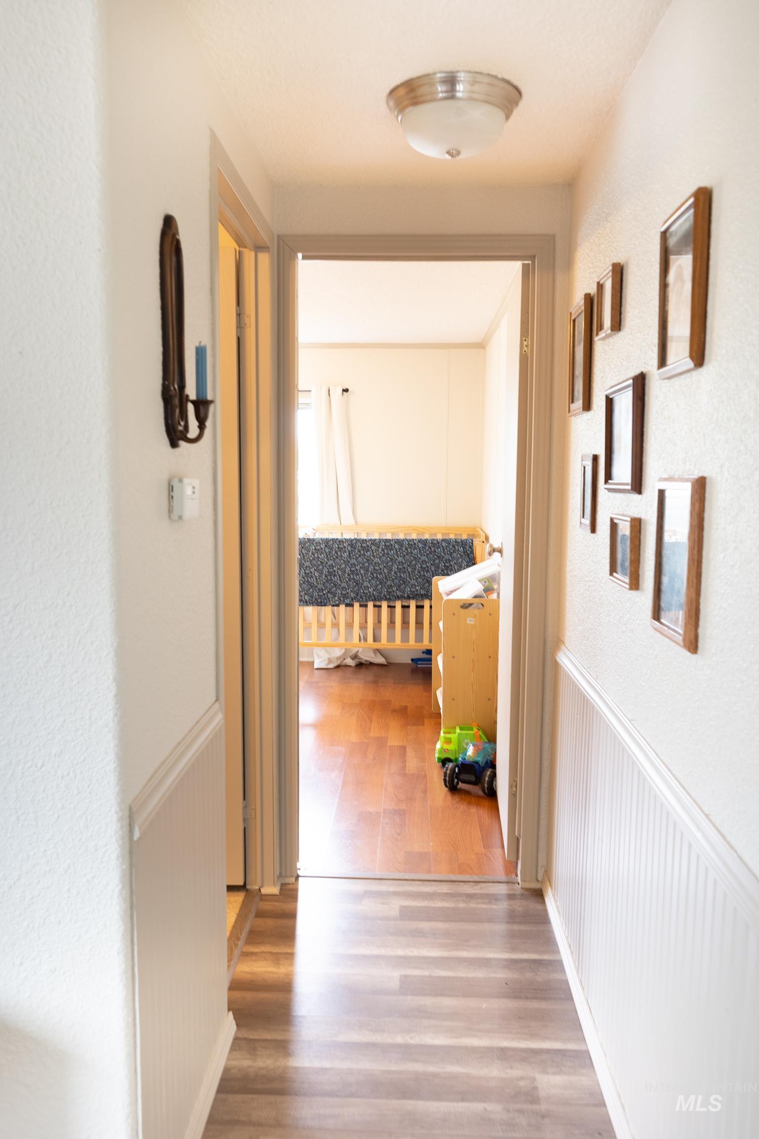 4325 Lenville Road, Unit 10 Moscow, ID 83843 - Photo 20 of 21 Hallway featuring light wood-style floors and a textured wall