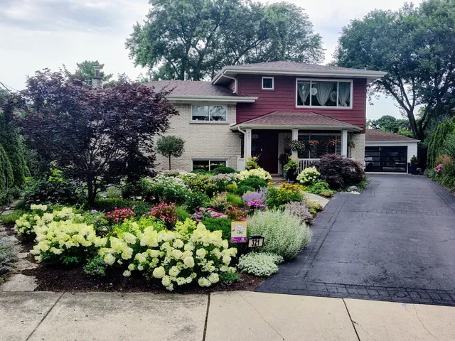 a front view of a house with a yard with yellow lighting