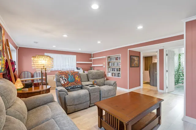 a front view of a house with a yard and a fountain