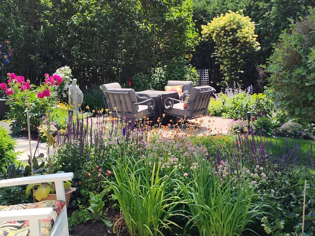 a view of a house with backyard and sitting area