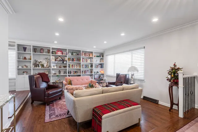 a living room with furniture a rug and a chandelier