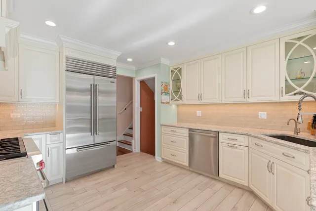 a kitchen with stainless steel appliances granite countertop a stove and a sink