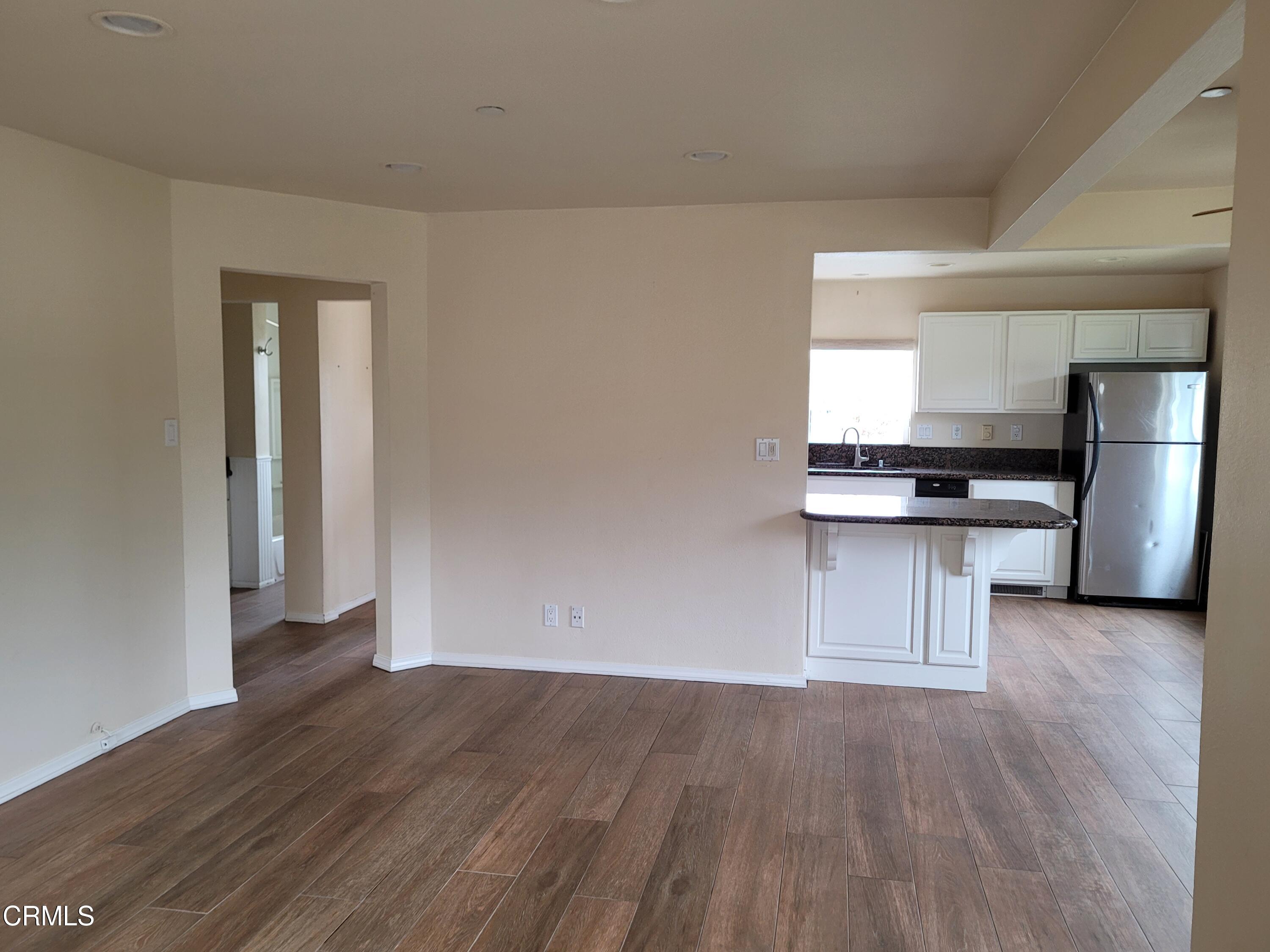 8614 Stockton Road Moorpark, CA 93021 - Photo 8 of 13 a kitchen with stainless steel appliances a refrigerator and wooden floor