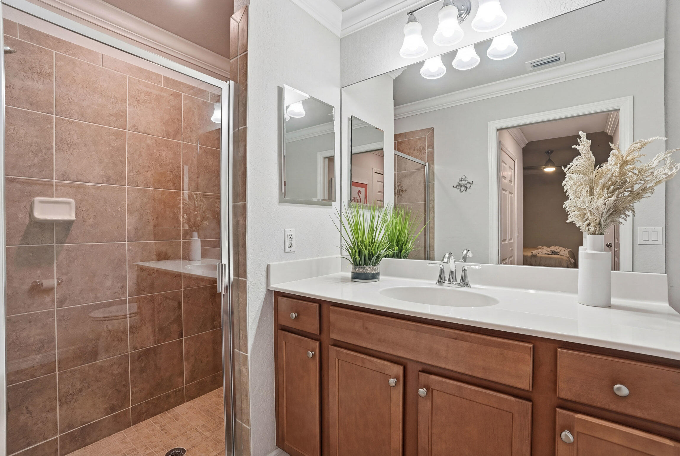 9560 Trevi Court, Unit 4812 Naples, FL 34113 - Photo 15 of 45 a bathroom with a sink a mirror and a shower
