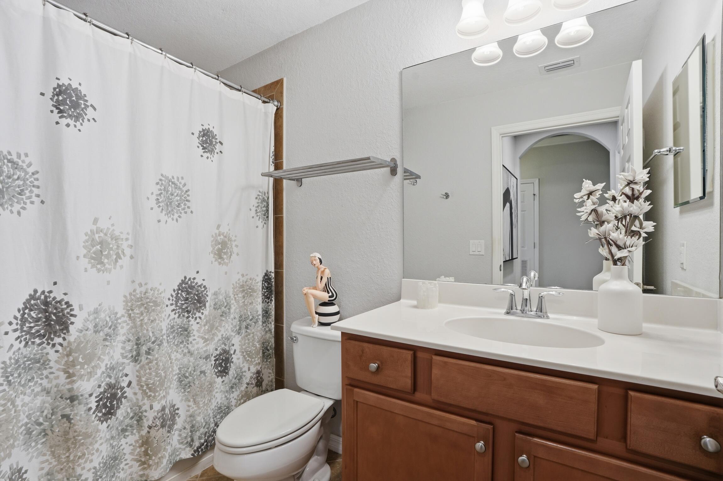 9560 Trevi Court, Unit 4812 Naples, FL 34113 - Photo 18 of 45 a bathroom with a sink a toilet and shower