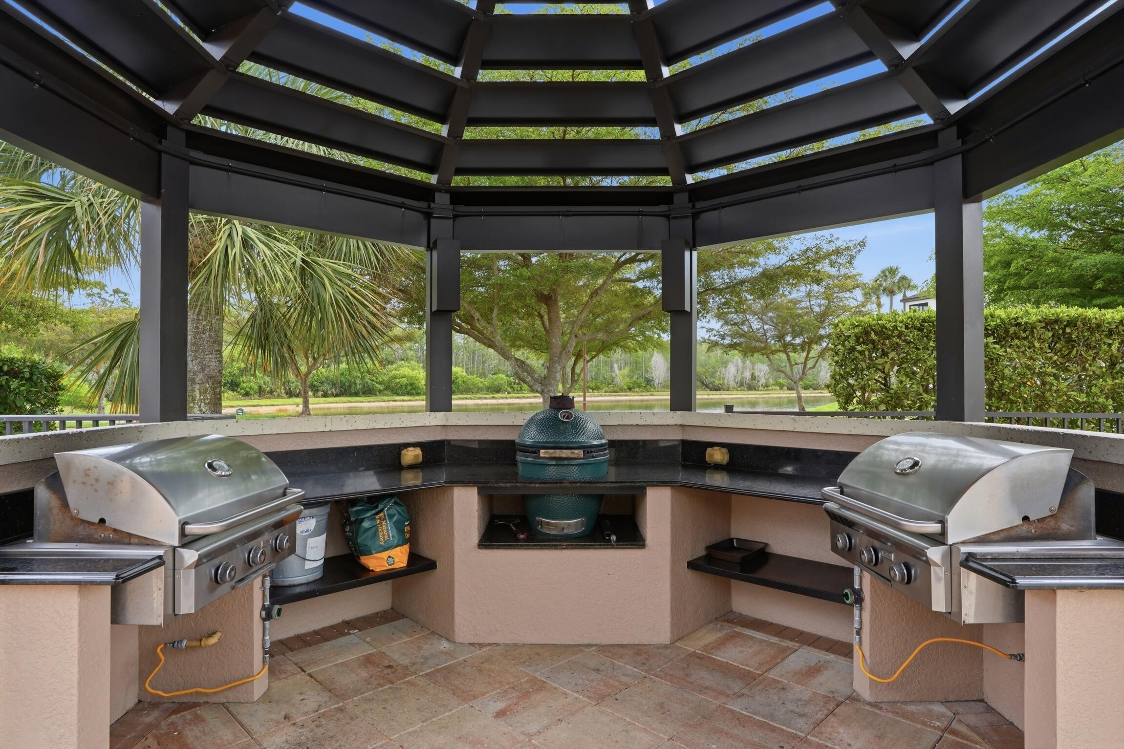 9560 Trevi Court, Unit 4812 Naples, FL 34113 - Photo 20 of 45 a kitchen area with furniture and a black umbrella