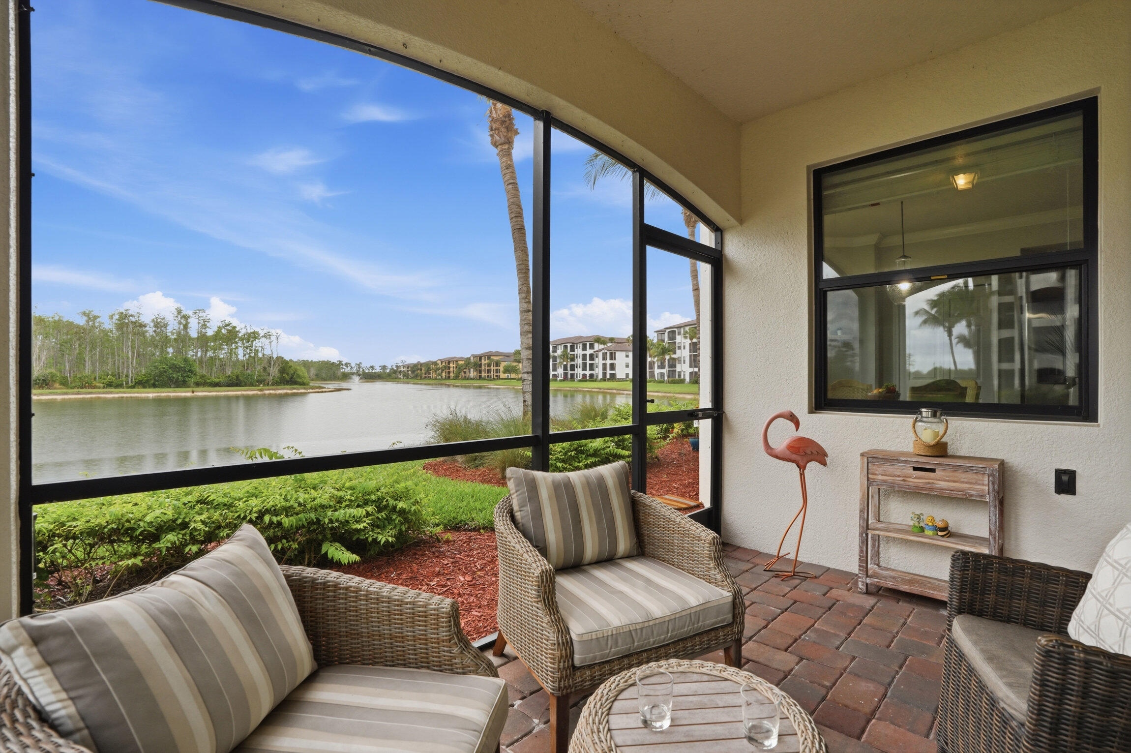 9560 Trevi Court, Unit 4812 Naples, FL 34113 - Photo 2 of 45 a balcony with furniture and a garden