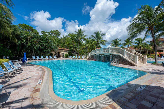 9560 Trevi Court, Unit 4812 Naples, FL 34113 - Photo 23 of 45 a view of a swimming pool with a patio