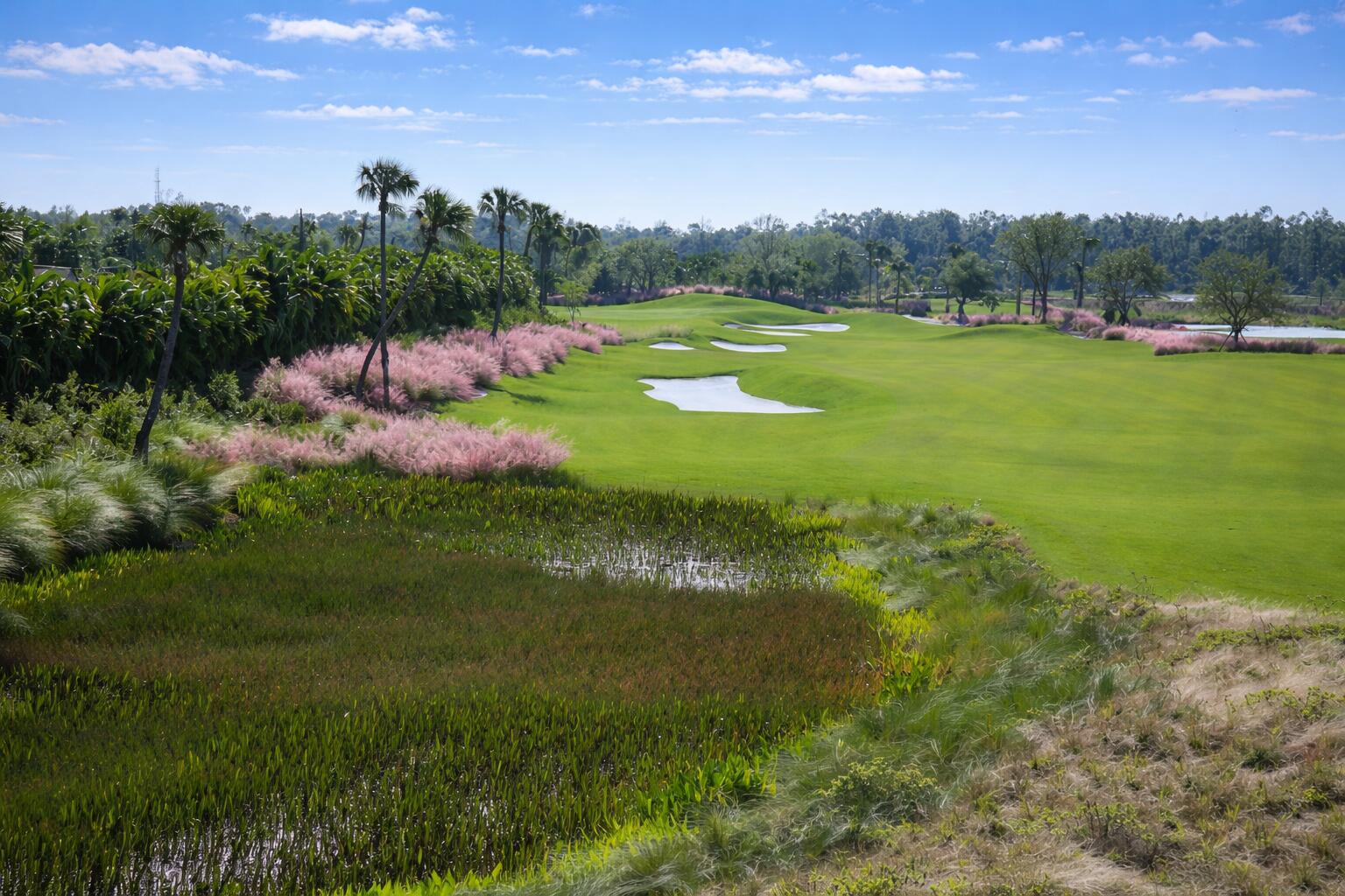 9560 Trevi Court, Unit 4812 Naples, FL 34113 - Photo 27 of 45 a view of a golf course with a lake
