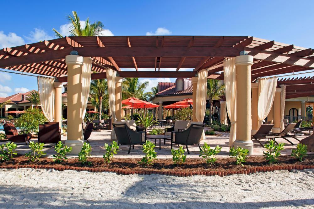 9560 Trevi Court, Unit 4812 Naples, FL 34113 - Photo 39 of 45 a view of a chairs and table in a patio