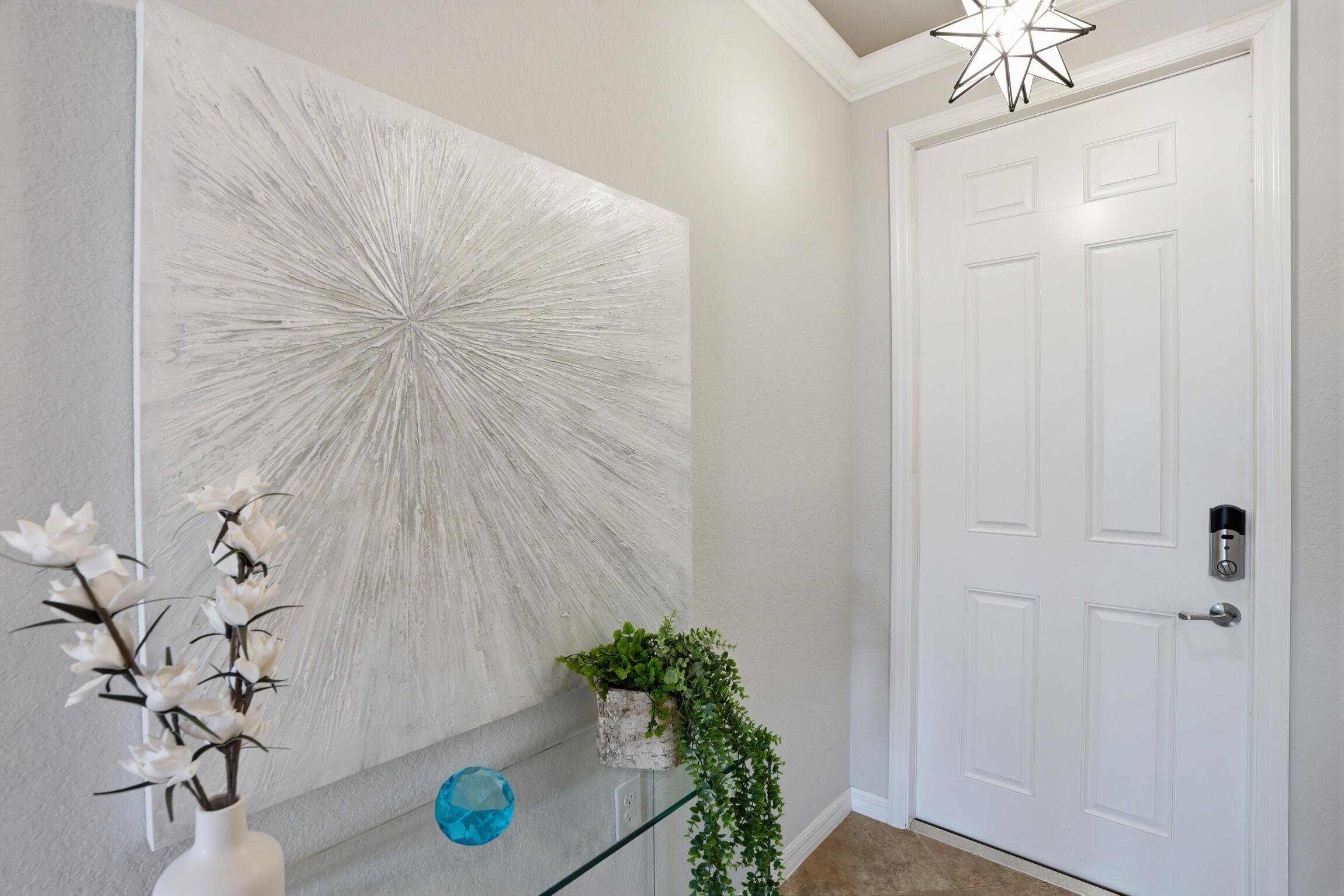 9560 Trevi Court, Unit 4812 Naples, FL 34113 - Photo 5 of 45 wooden floor with a potted plant on a wall