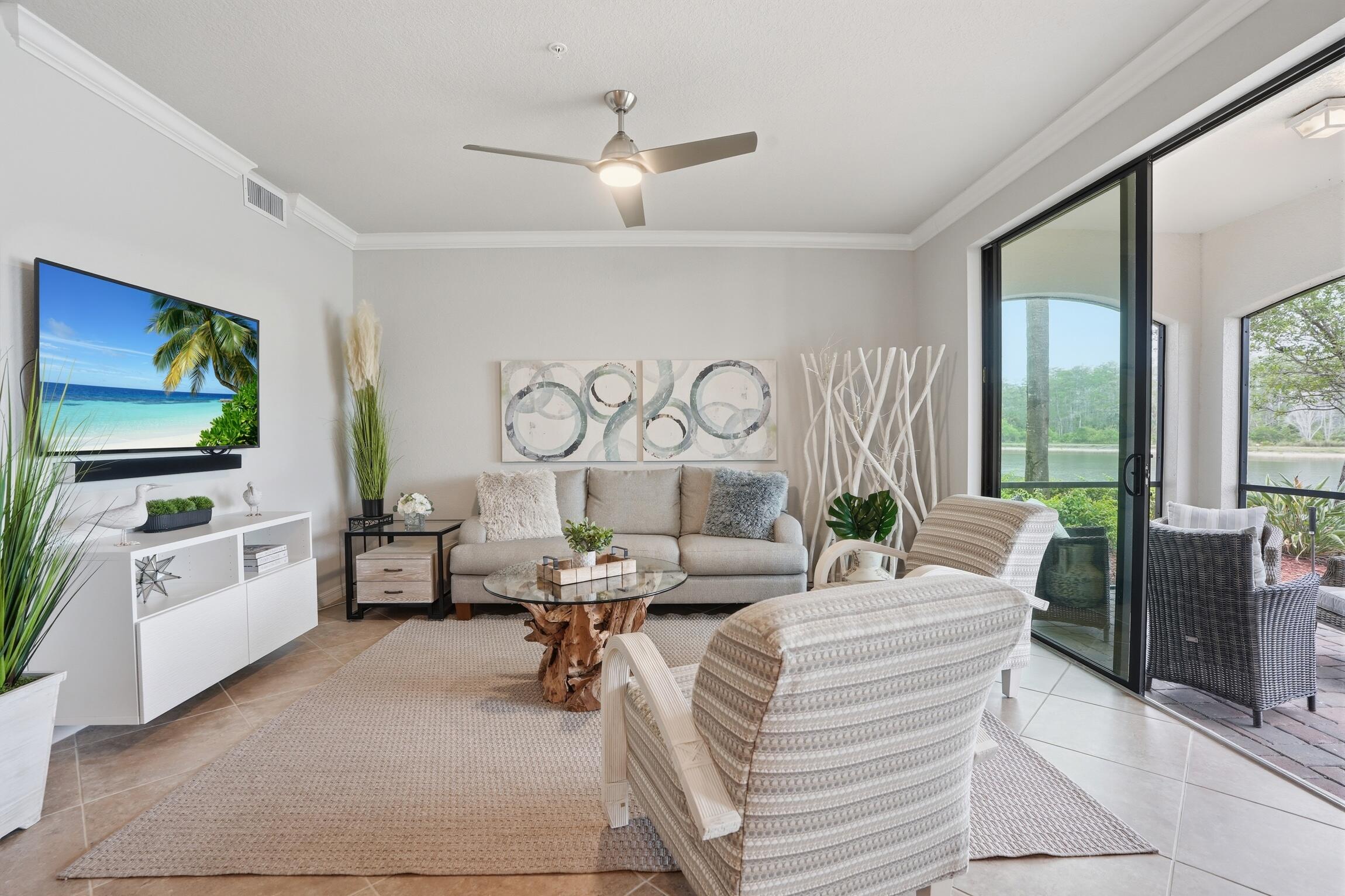 9560 Trevi Court, Unit 4812 Naples, FL 34113 - Photo 6 of 45 a living room with fireplace furniture and a flat screen tv