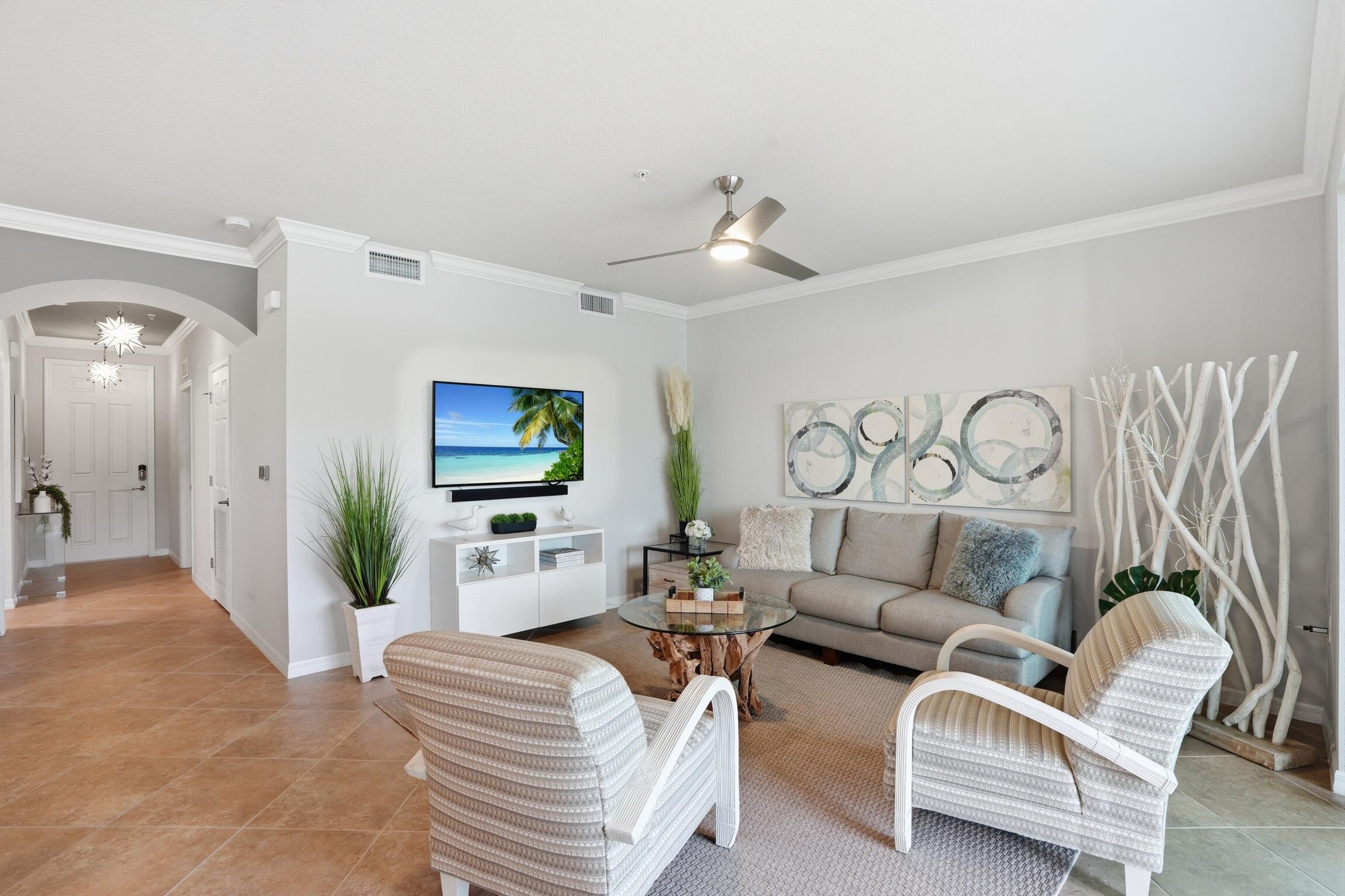 9560 Trevi Court, Unit 4812 Naples, FL 34113 - Photo 7 of 45 a living room with furniture a rug and white walls