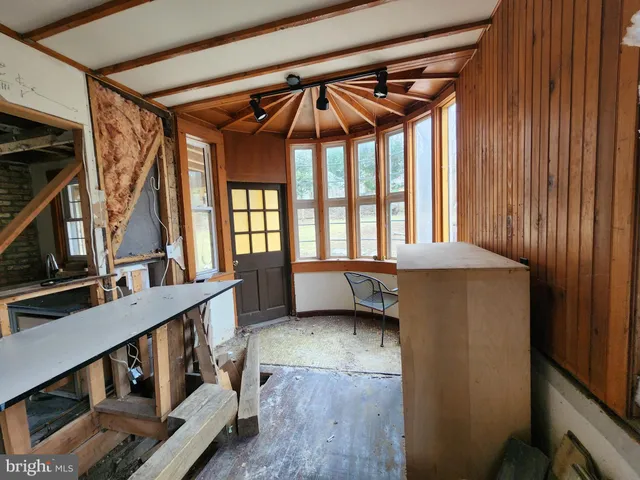 a view of a porch with furniture and a window