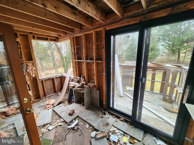 a view of work room with wooden floor and furniture