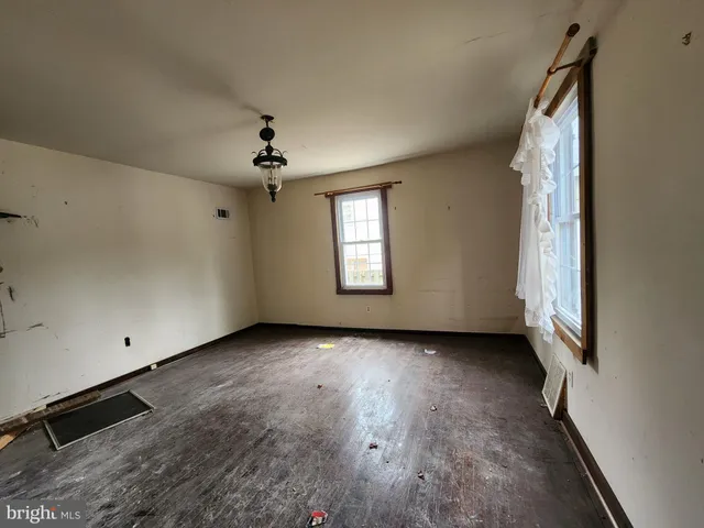 a view of a livingroom with a ceiling fan and window