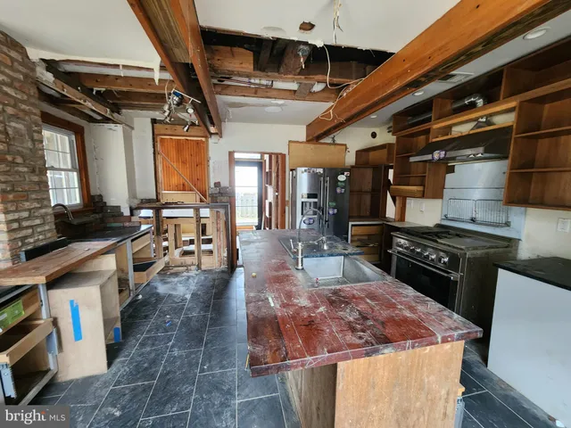 a large kitchen with stainless steel appliances granite countertop a stove a sink dishwasher and cabinets