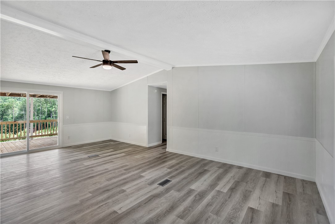 403 Hancox Place Westminster, SC 29693 - Photo 24 of 39 A living space with plank flooring opens to a private wooded balcony.