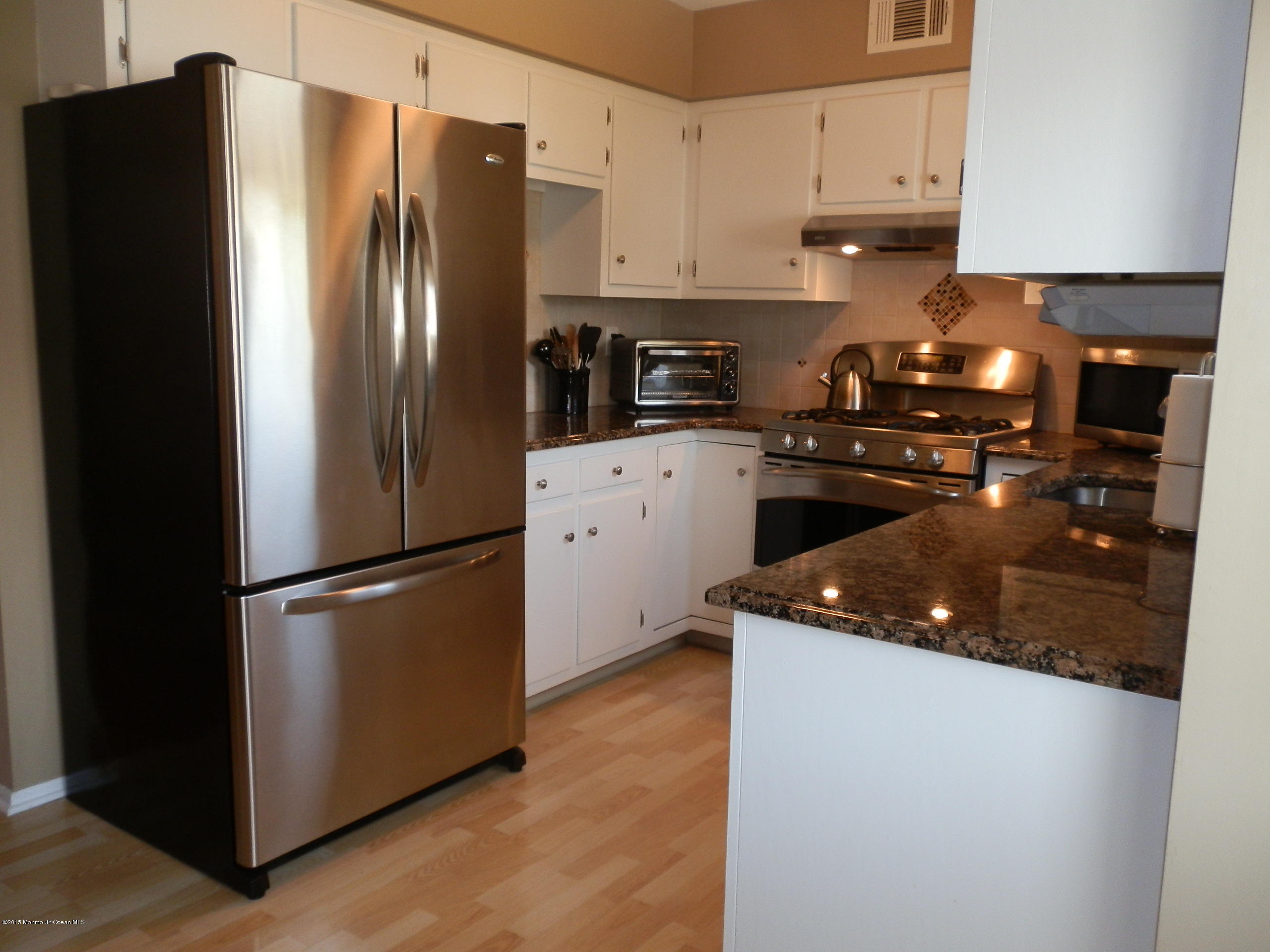 423 Middlewood Road Middletown, NJ 07748 - Photo 1 of 24 a kitchen with stainless steel appliances granite countertop a refrigerator a stove a sink and a granite counter tops