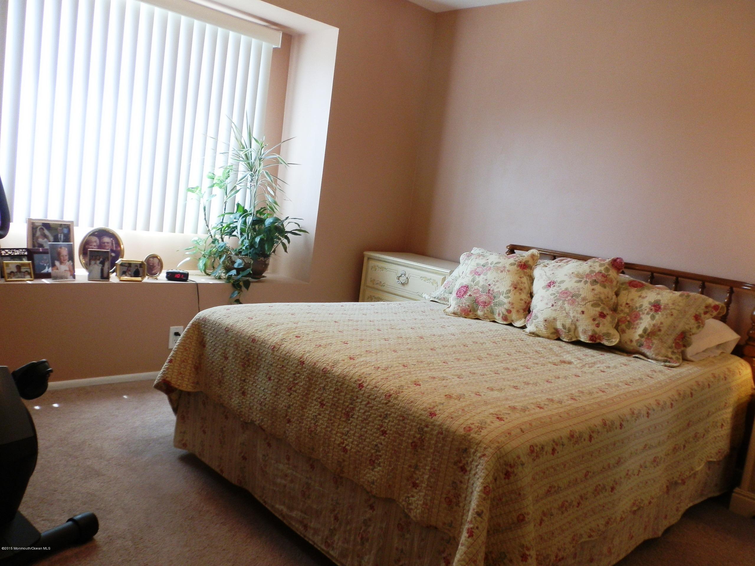 423 Middlewood Road Middletown, NJ 07748 - Photo 15 of 24 a bedroom with a bed and a large window