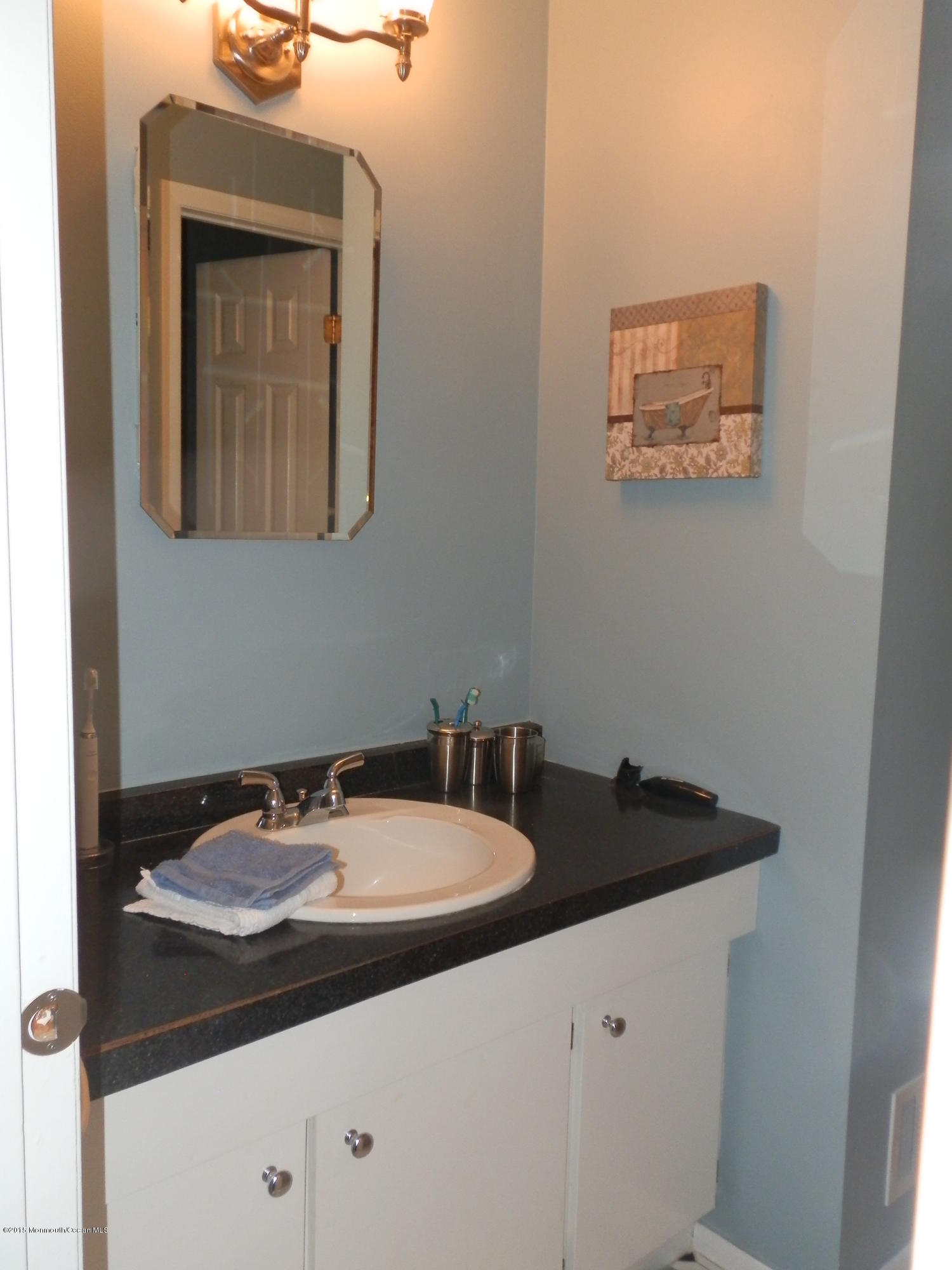 423 Middlewood Road Middletown, NJ 07748 - Photo 16 of 24 a bathroom with a sink and a mirror