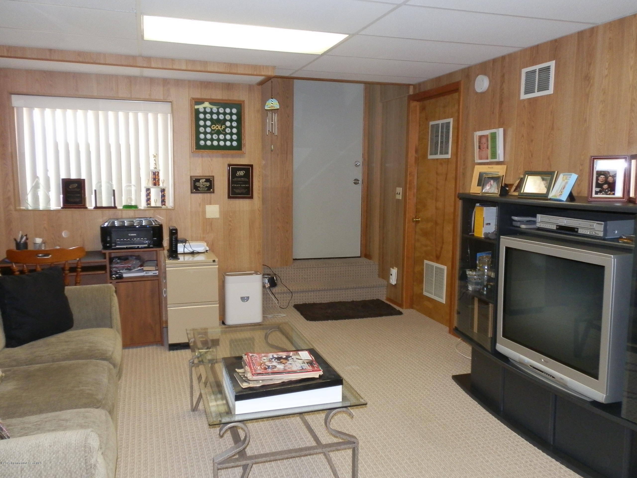 423 Middlewood Road Middletown, NJ 07748 - Photo 18 of 24 a living room with furniture a rug and a fireplace