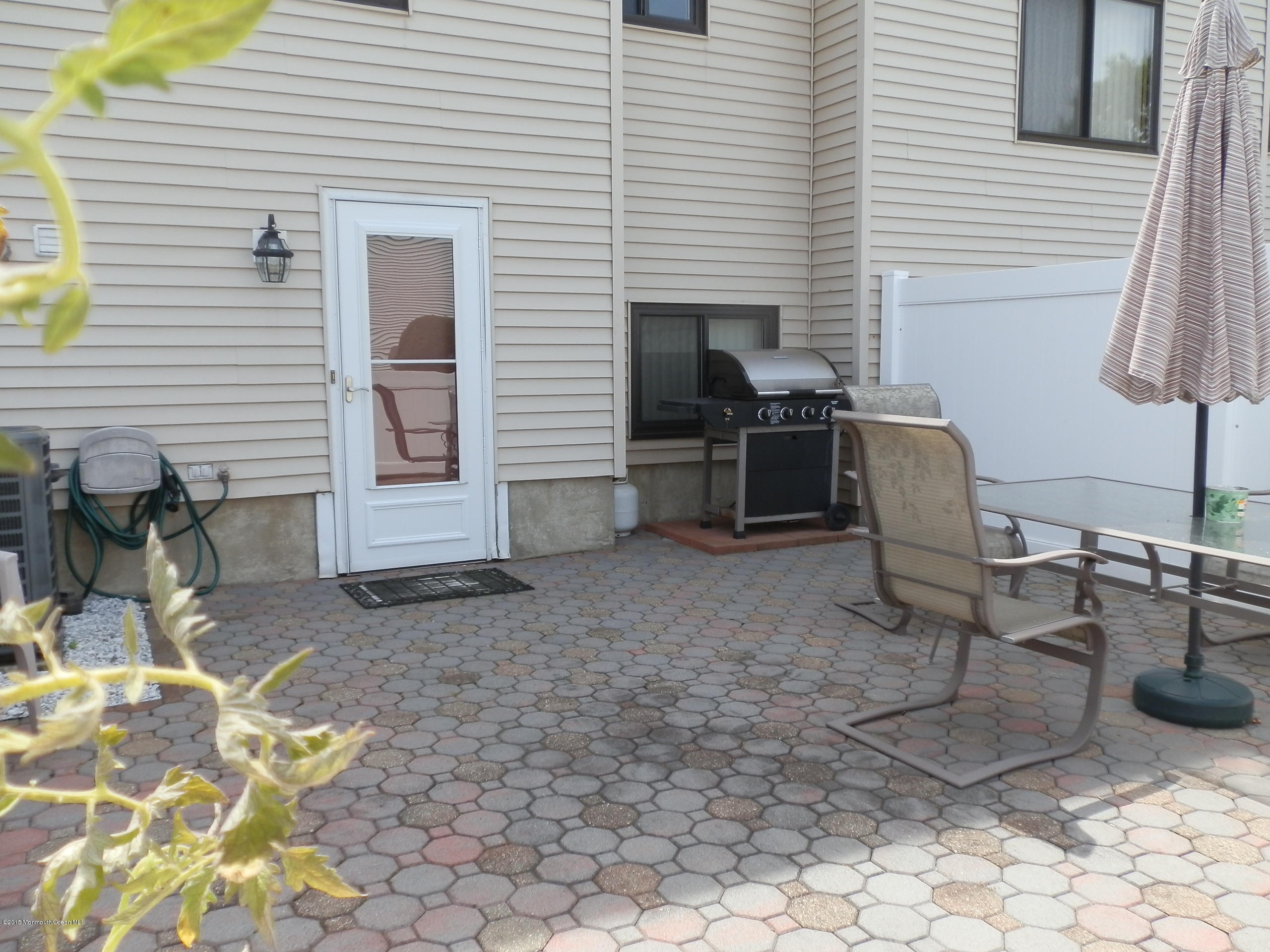 423 Middlewood Road Middletown, NJ 07748 - Photo 19 of 24 a view of a chairs and table in the back yard of the house