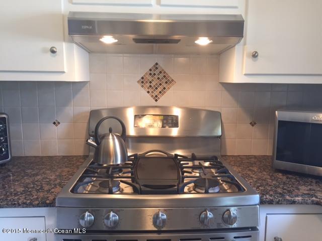 423 Middlewood Road Middletown, NJ 07748 - Photo 8 of 24 a stove top oven sitting inside of a kitchen