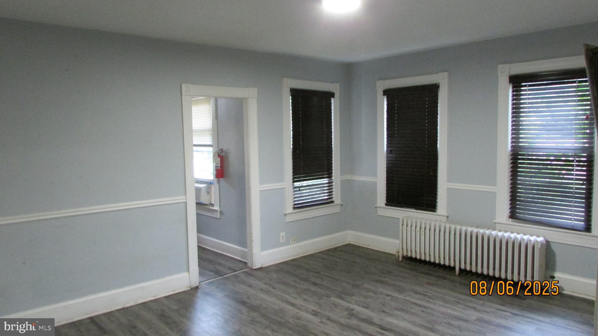 4724 Branchville Road College Park, MD 20740 - Photo 11 of 41 an empty room with wooden floor and windows