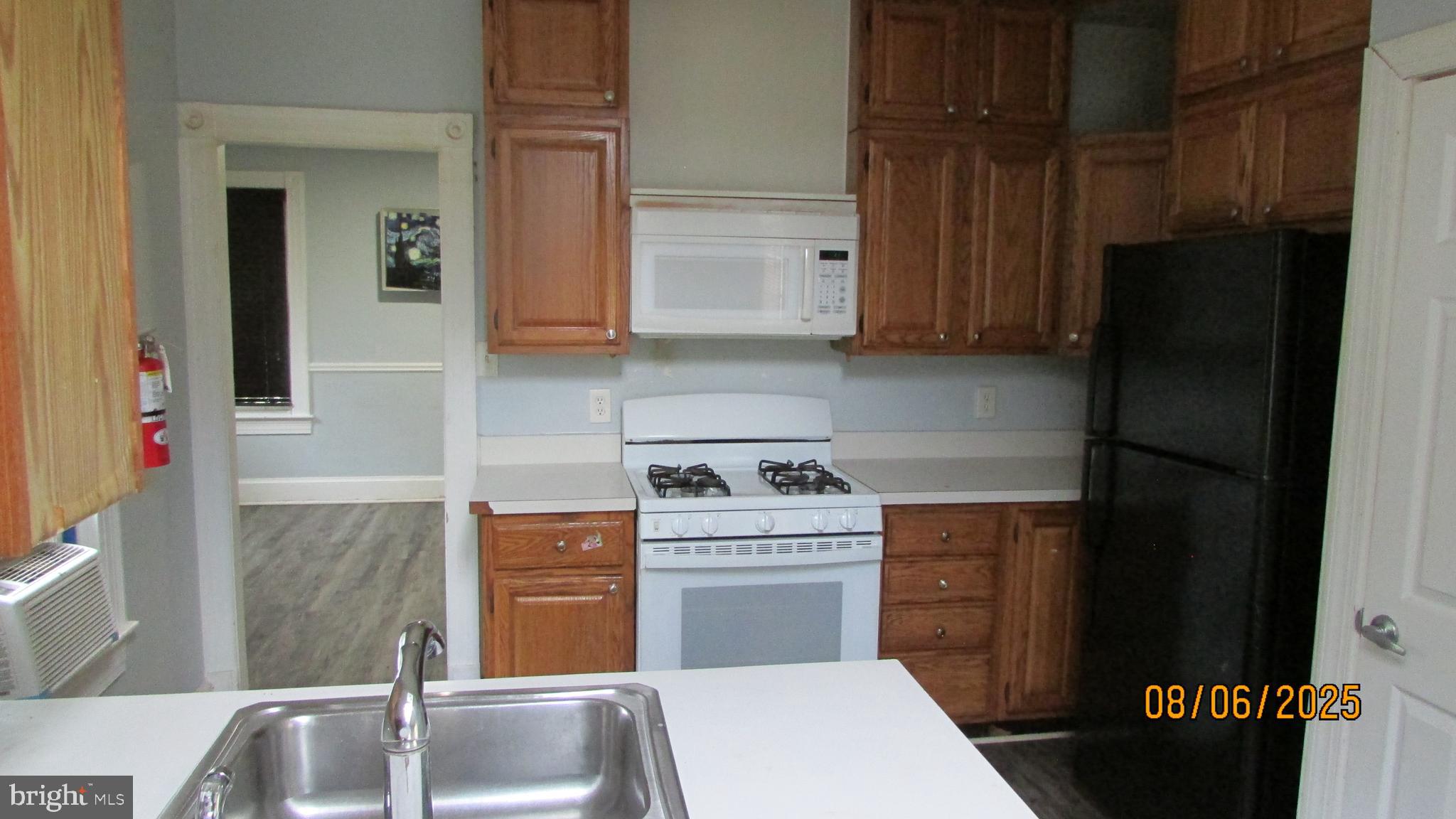 4724 Branchville Road College Park, MD 20740 - Photo 14 of 41 a kitchen with a sink stove and refrigerator